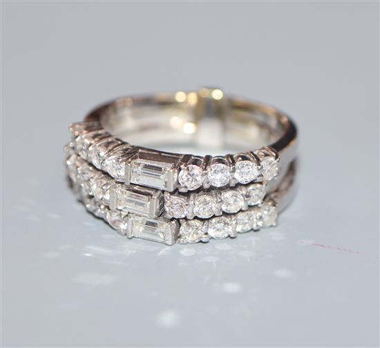 A white metal, baguette and round cut diamond set triple band ring, size